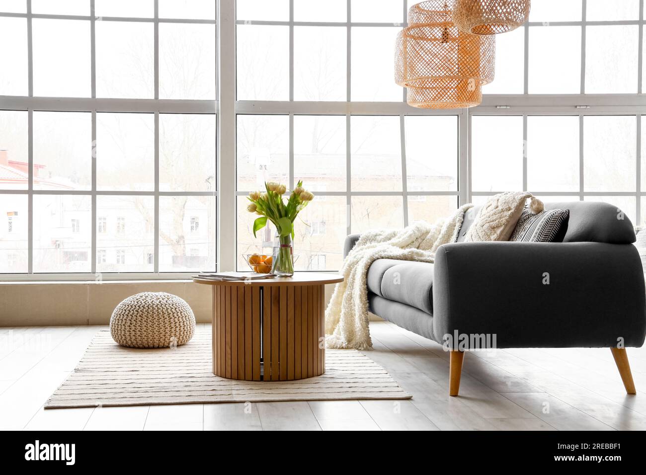 Interior of stylish living room with cozy sofa and coffee table near ...