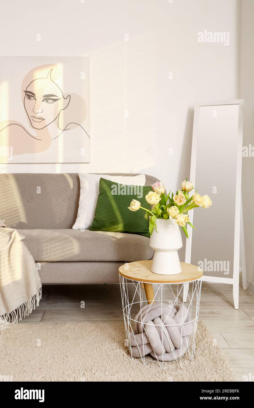 Interior of living room with grey sofa, table and mirror Stock Photo ...
