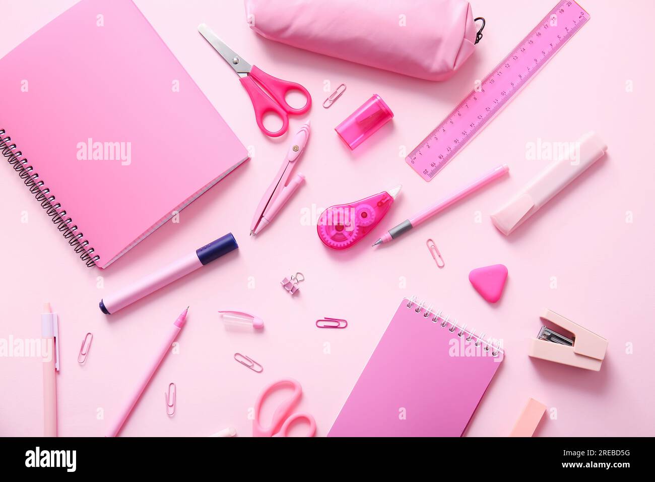 Different school stationery and notebooks on pink background Stock Photo
