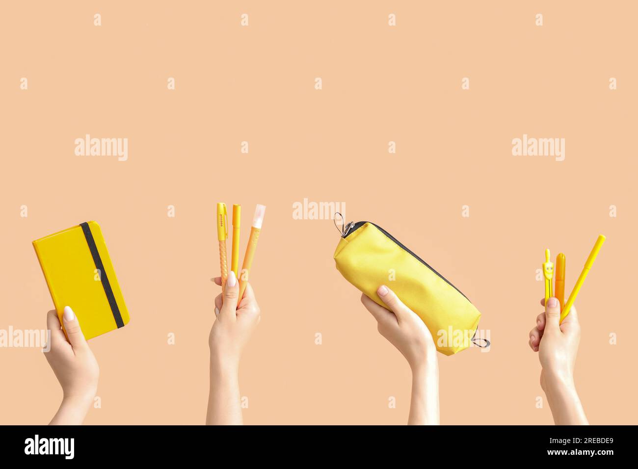 Female hands with school supplies on beige background Stock Photo - Alamy