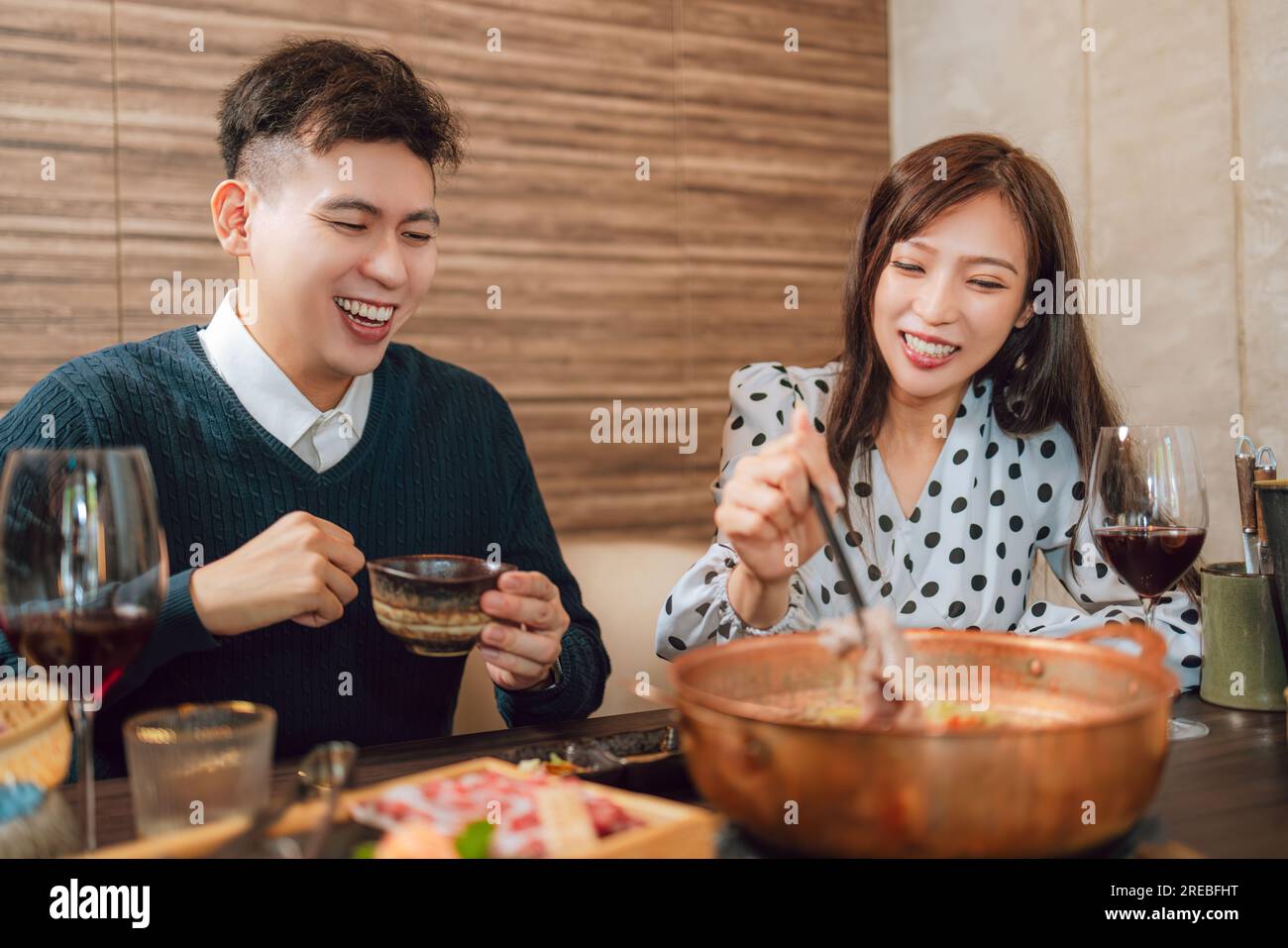 Happy couple dining in hotpots restaurant Stock Photo