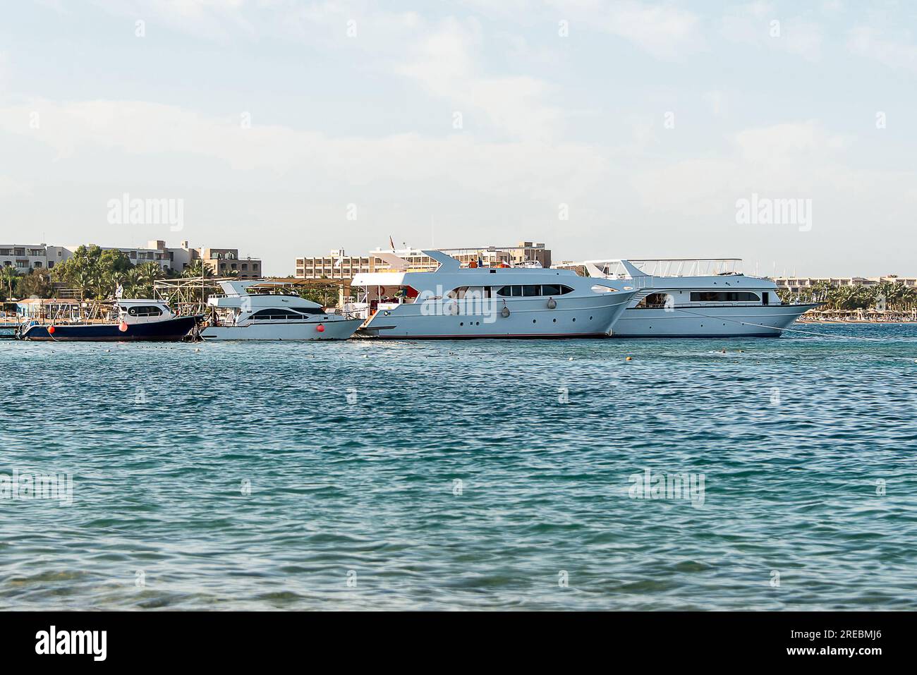 Tourist boat silhouetts on the shores of the red sea in Makadi Bay ...
