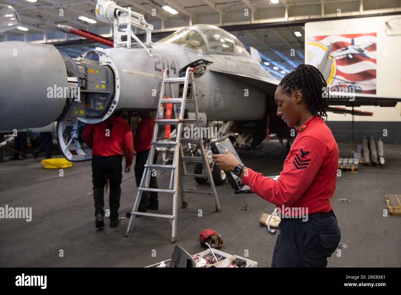 California, USA. 16th July, 2023. Aviation Ordnanceman 1st Class Rholanda Tucker, from Palmdale, California, assigned to the ''Blacklions'' of Strike Fighter Squadron (VFA) 213, conducts routine maintenance on the 20mm gun from an F/A-18F Super Hornet in the hangar bay of the world's largest aircraft carrier USS Gerald R. Ford (CVN 78), July 16, 2023. Gerald R. Ford is the U.S. Navy's newest and most advanced aircraft carrier, representing a generational leap in the U.S. Navy's capacity to project power on a global scale. The Gerald R. Ford Carrier Strike Group is on a scheduled deployment in Stock Photo