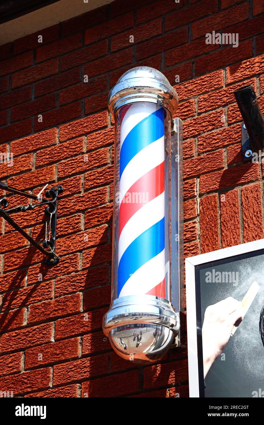 Barbers pole outside a barbers shop along Fore Street, Chard, Somerset, UK, Europe. Stock Photo