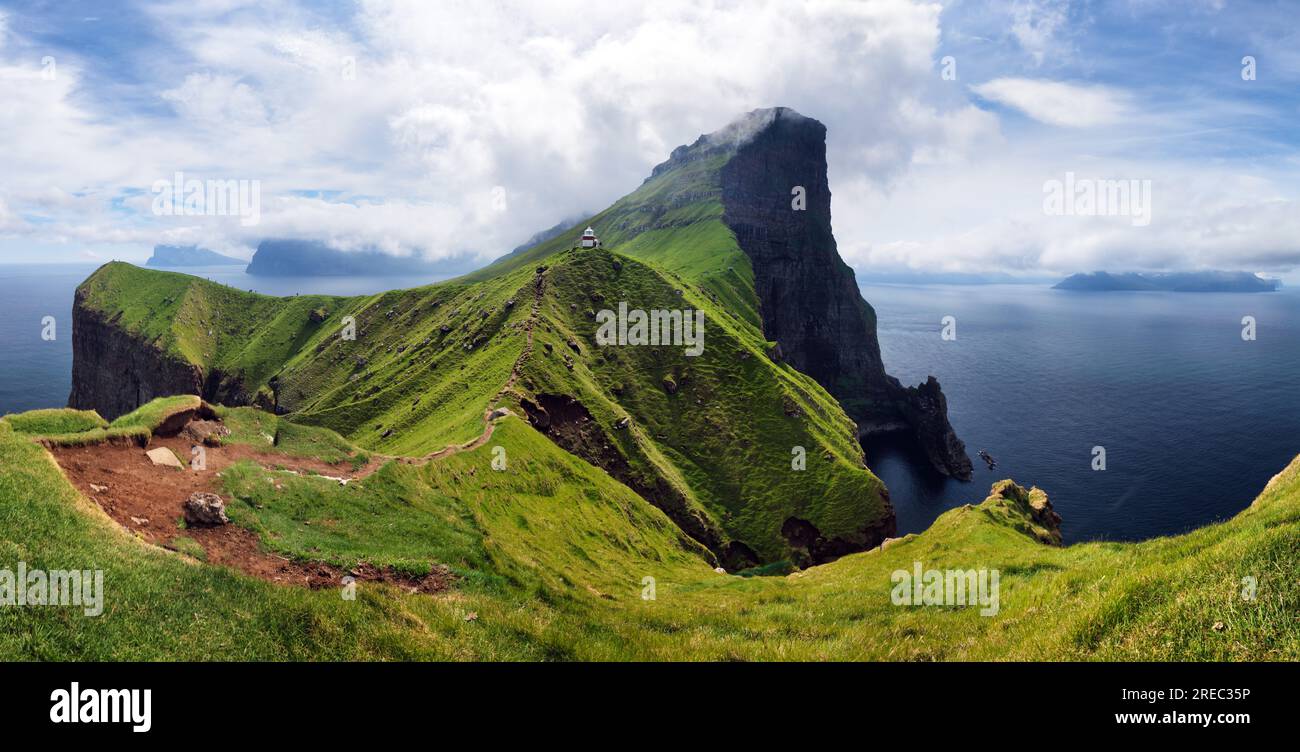 Kallur lighthouse on green hills of Kalsoy island, Faroe islands, Denmark. Landscape photography Stock Photo
