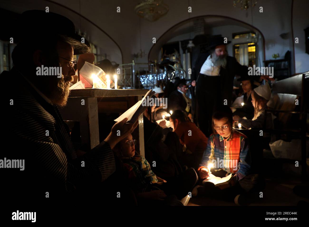 Jerusalem. 26th July, 2023. Ultra-Orthodox Jews light candles to read the Book of Lamentations during the annual fasting and memorial day of Tisha B'Av in the Ultra-Orthodox neighborhood of Mea Shearim in Jerusalem on July 26, 2023. Credit: Gil Cohen Magen/Xinhua/Alamy Live News Stock Photo