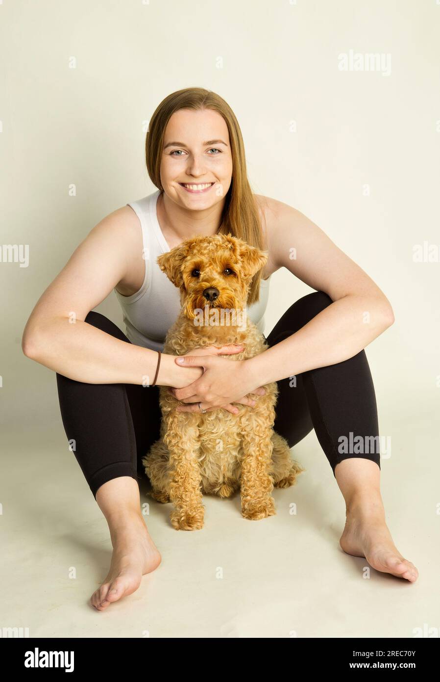 A girl with her pet schnoodle Stock Photo