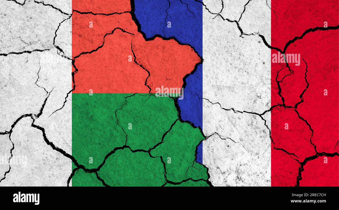 Flags of Madagascar and France on cracked surface politics