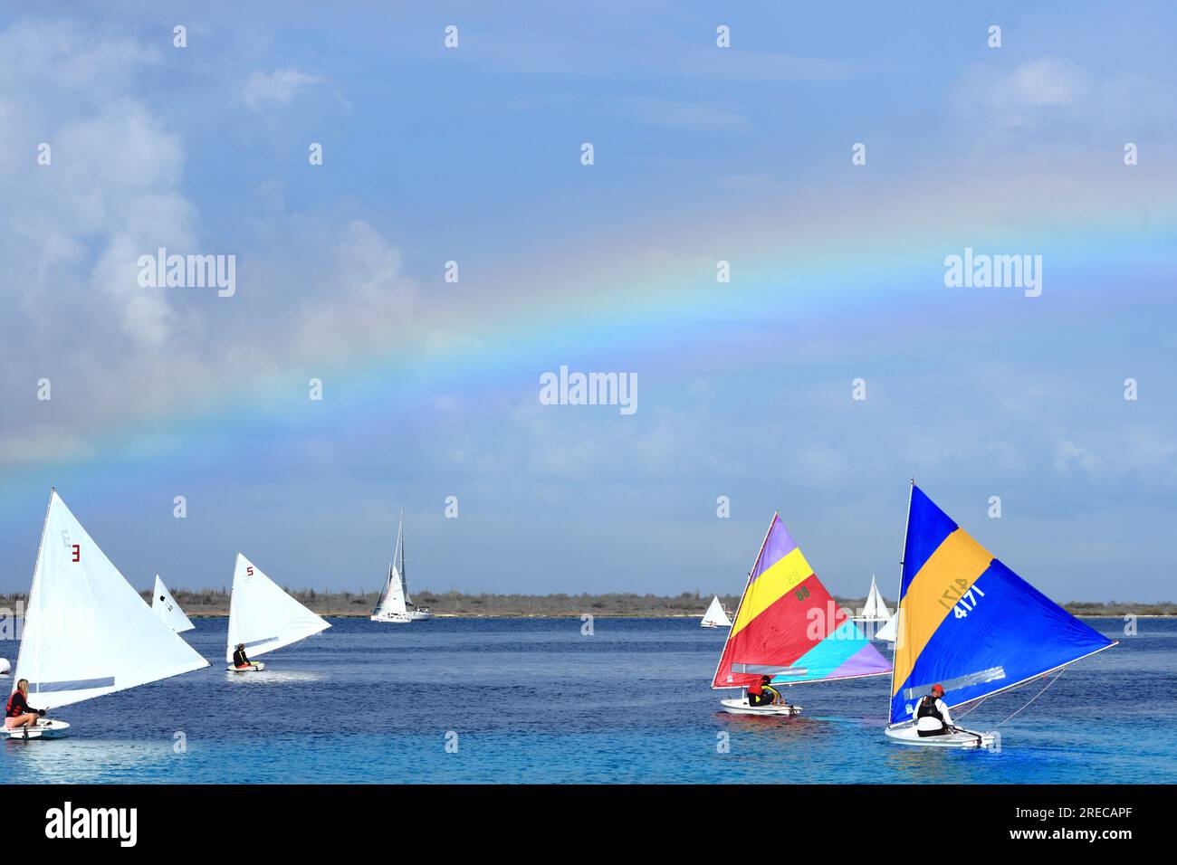 Sailing regatta competition sunfish boats sport colorful rainbow sky Caribbean coast Stock Photo