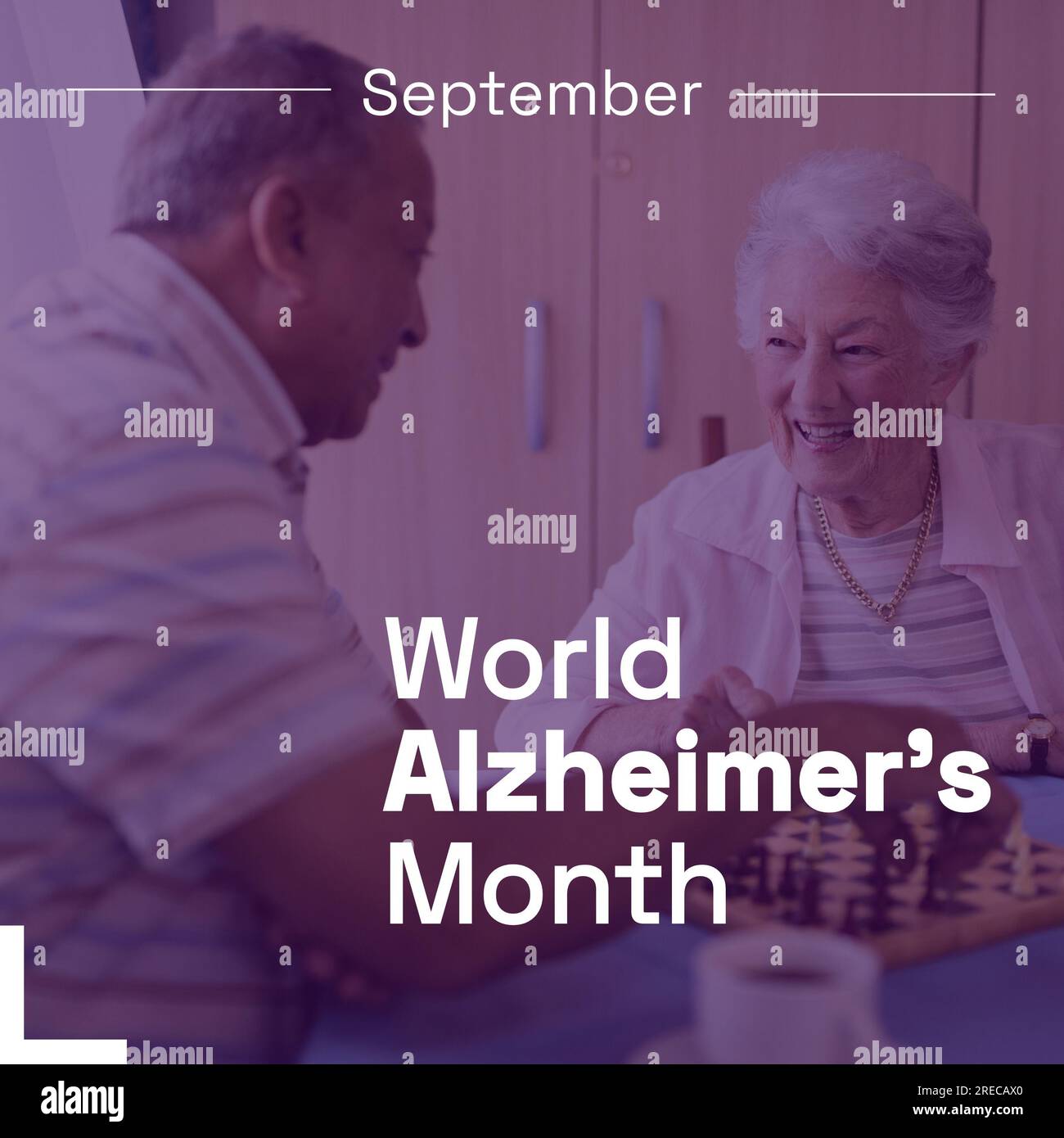 September world alzheimer's month text over happy senior biracial couple playing chess Stock Photo