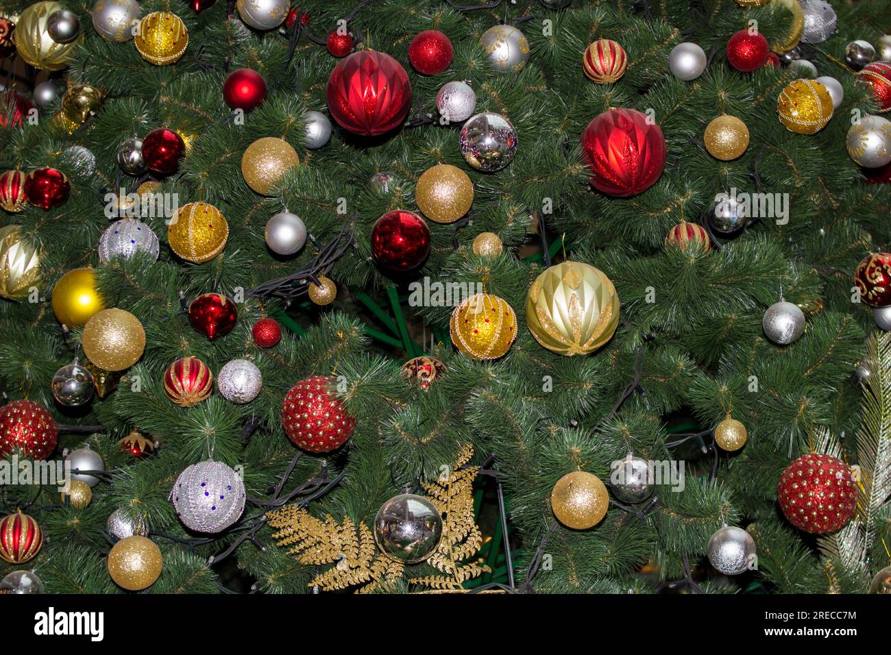 beautiful Christmas tree is decorated with bullets and garlands Stock