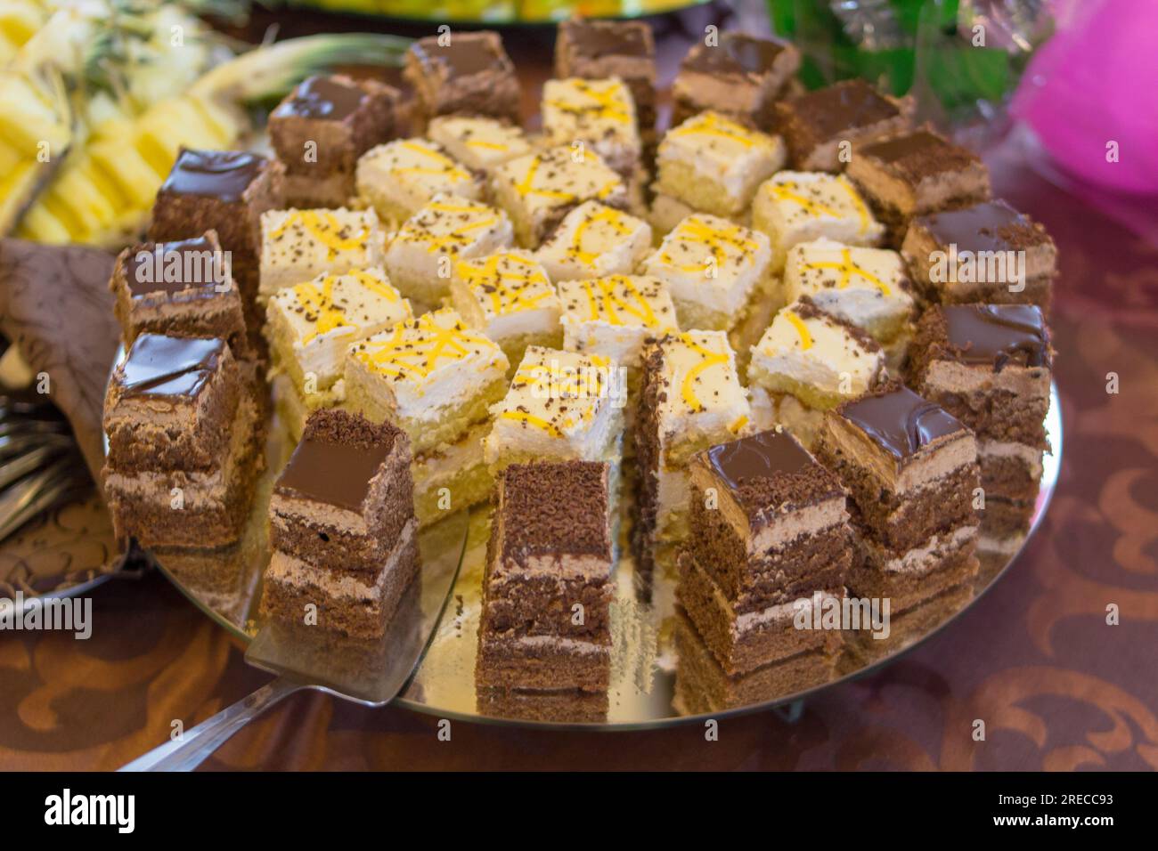 On a buffet table cut pieces of cake Stock Photo