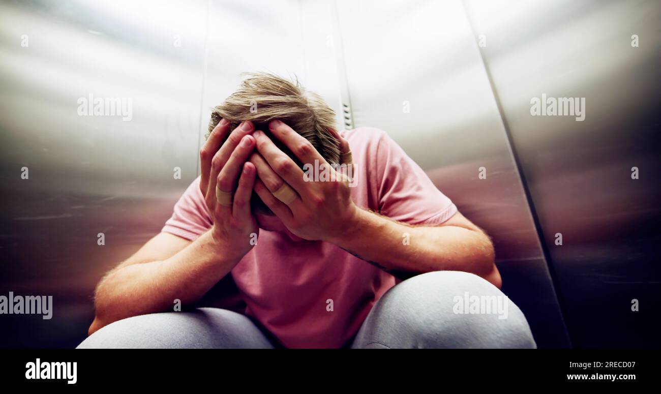 Man Suffering From Claustrophobia Trapped Inside Elevator Screaming Stock Photo