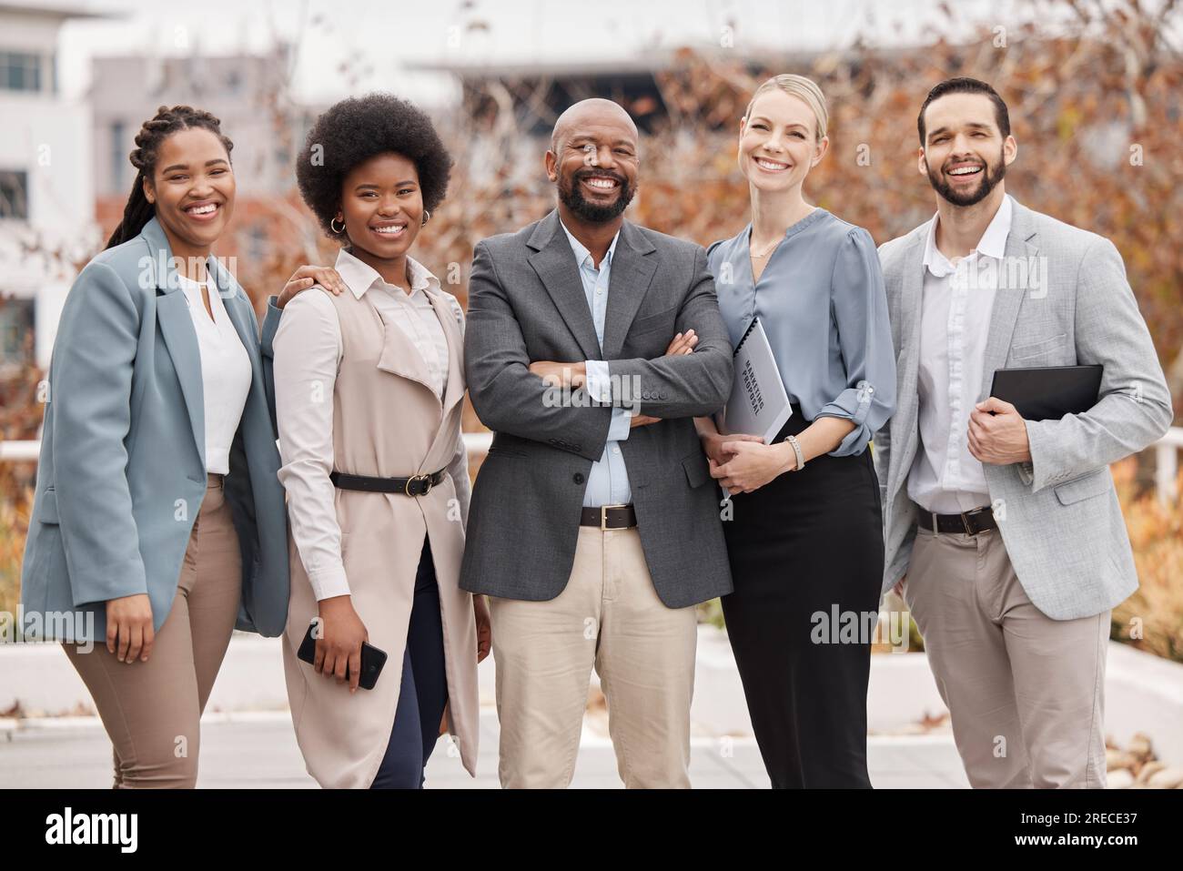 Team, portrait and business people with arms crossed in the city for ...