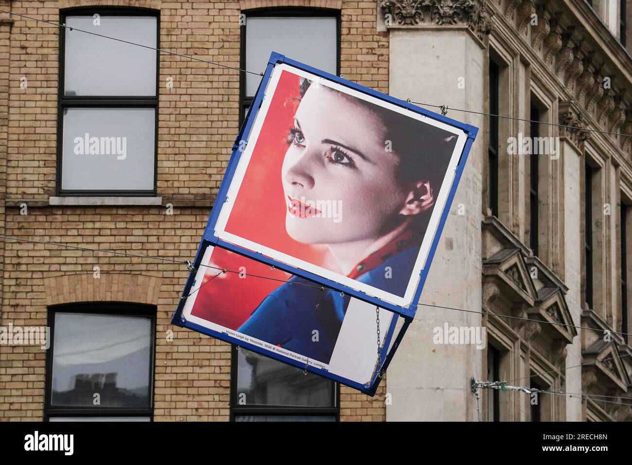One of over 50 giant cubes featuring portraits of UK entertainers above the streets surrounding