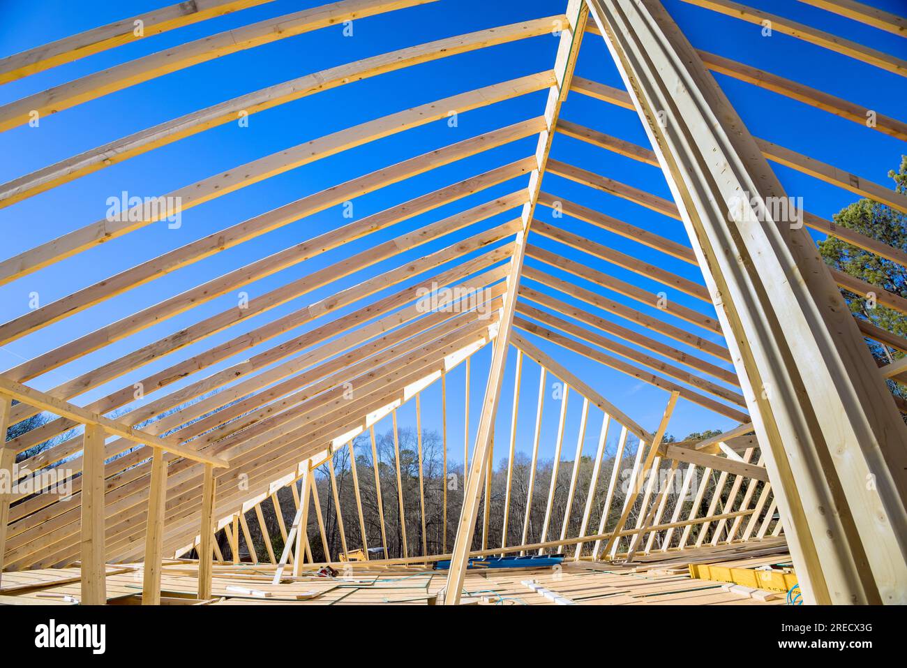 Wood frame truss roofing is constructed at new house construction site
