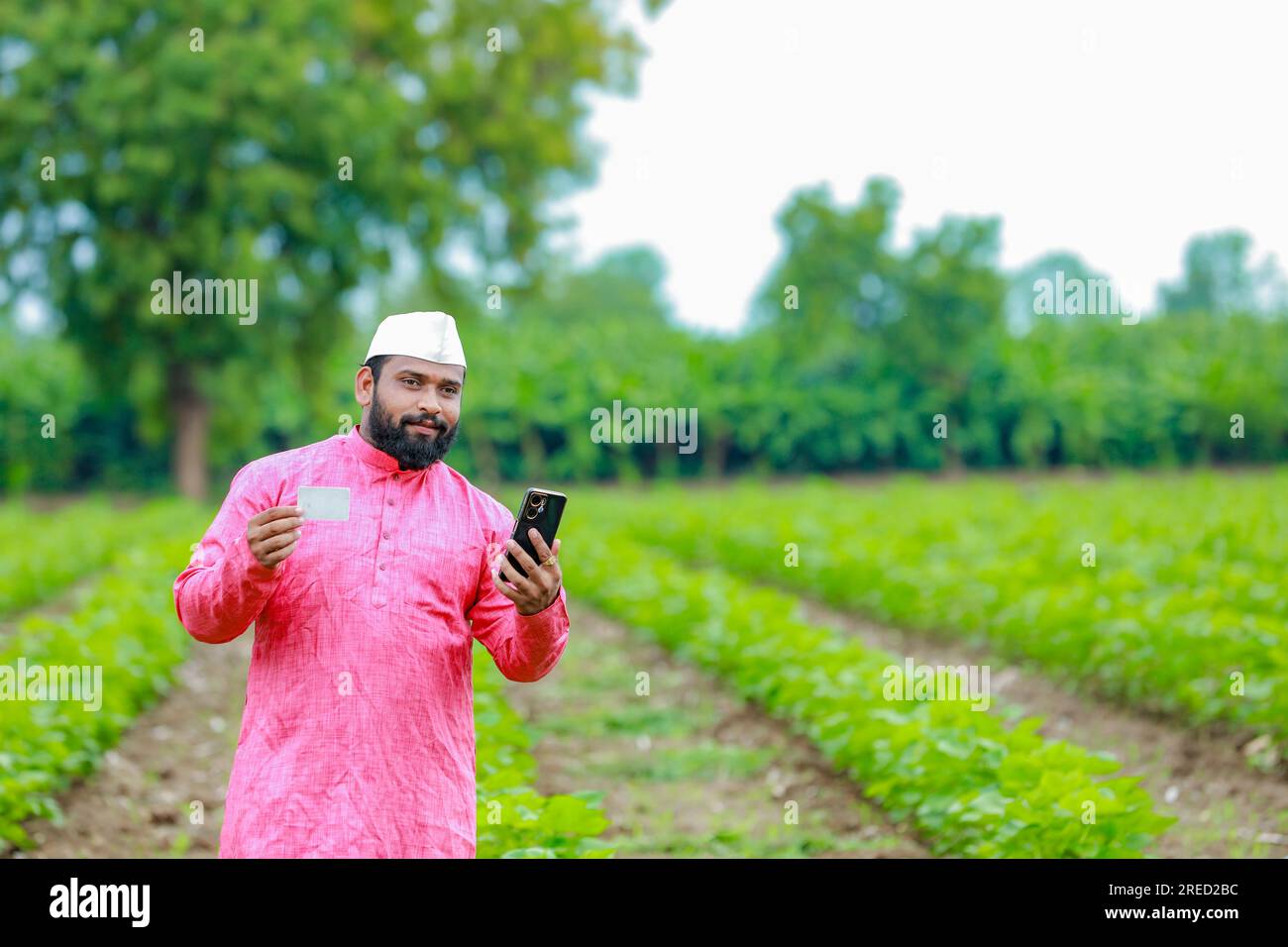 Indian farmer Holding ATM card in hands , happy indian farmer, poor farmer, worker Stock Photo