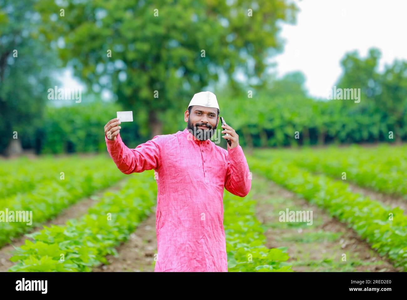 indian farmer holding atm card in hands happy indian farmer poor farmer worker 2RED2E0