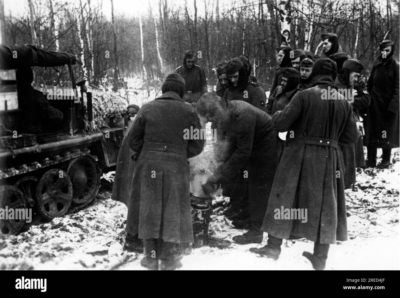 German soldiers receive hot food. In the background a tractor Sdkfz. 10 1to. Photo: Tepper. [automated translation] Stock Photo