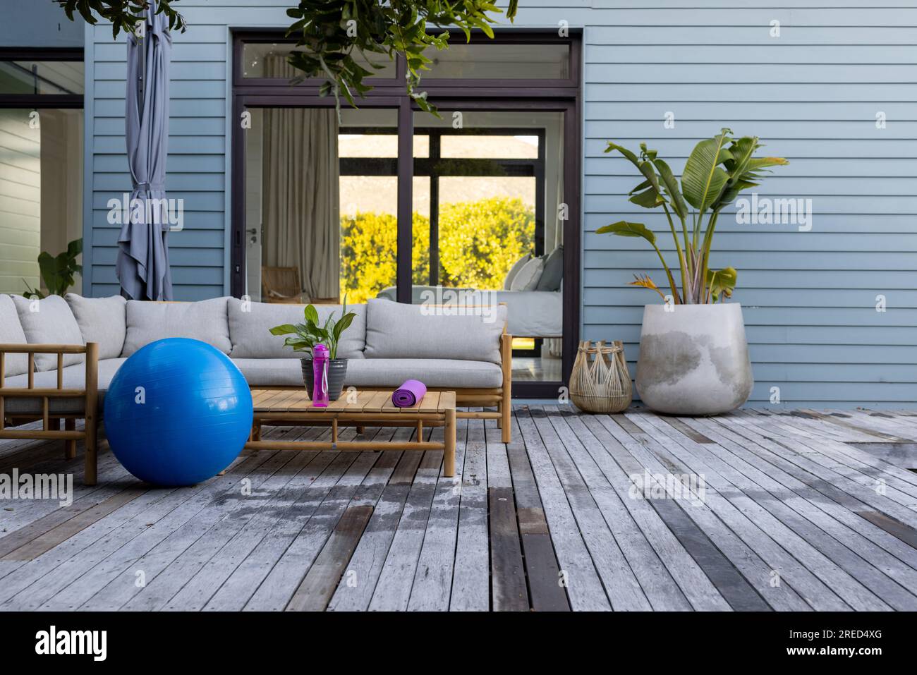 General view of terrace with sofa and fitness equipment Stock Photo