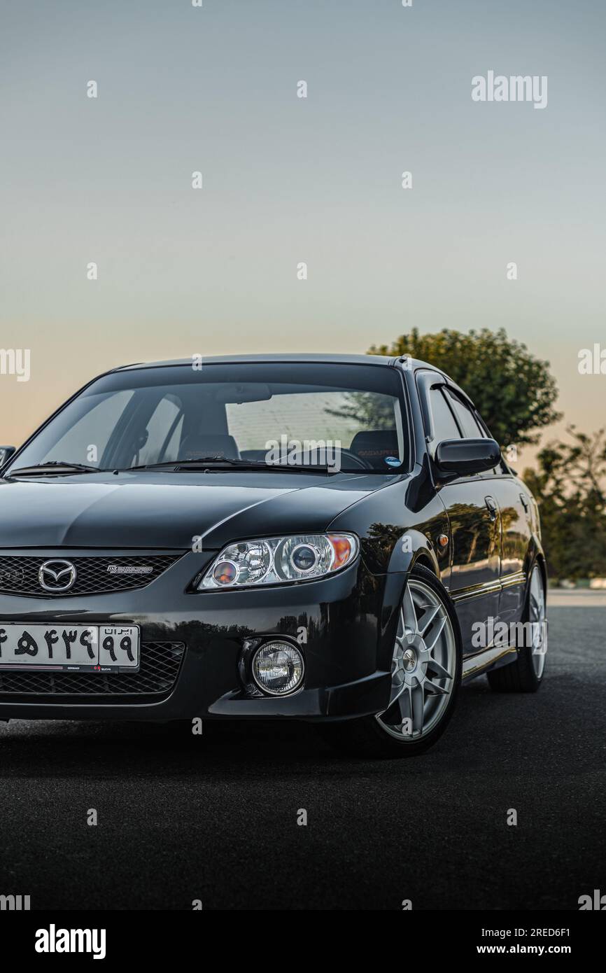 black mazda 323 speed protege Stock Photo Alamy
