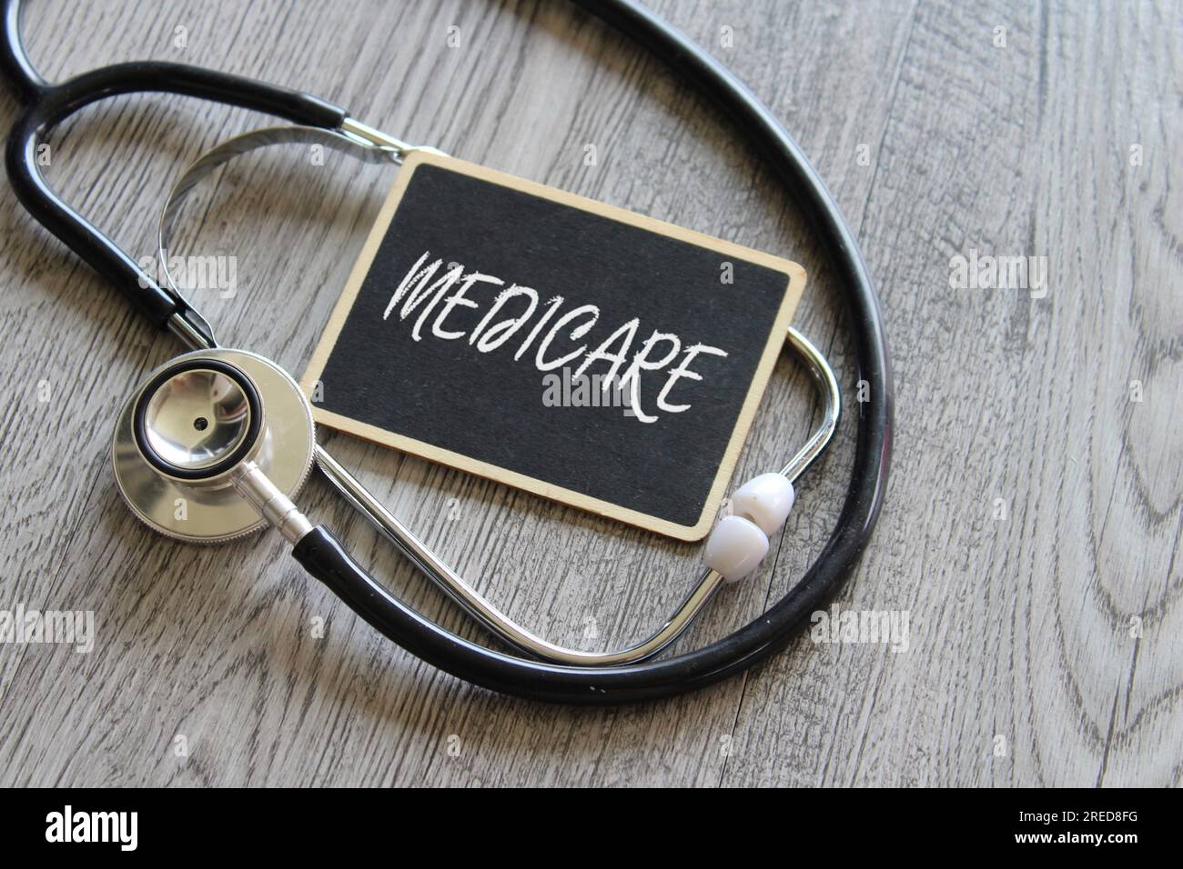 Close up image of stethoscope and chalkboard with text MEDICARE. Medical and healthcare concept Stock Photo
