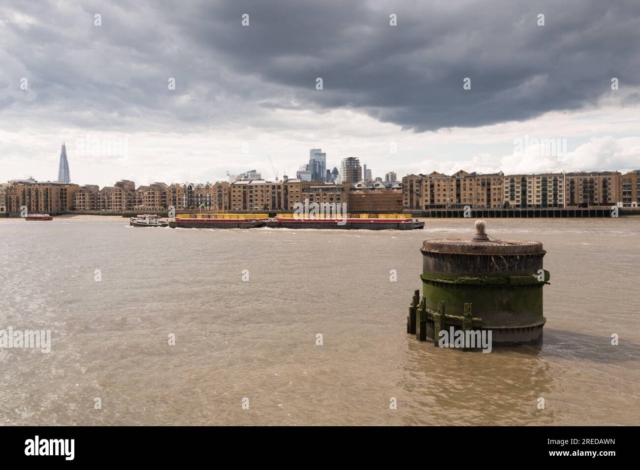 Distant Central Business District skyscrapers and the London skyline juxtaposed against the River Thames at Limehouse, London, E1, England, U.K. Stock Photo