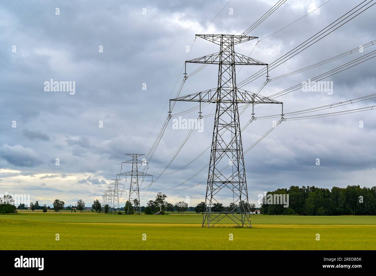Power lines over fields a cloudy summers day Stock Photo - Alamy