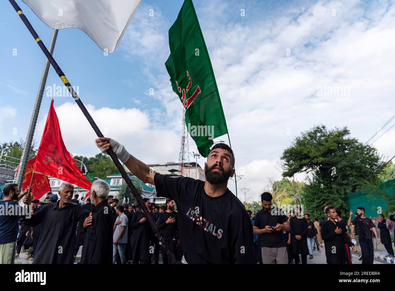 A Shia Muslim mourner waves a religious flag during a procession on the ...