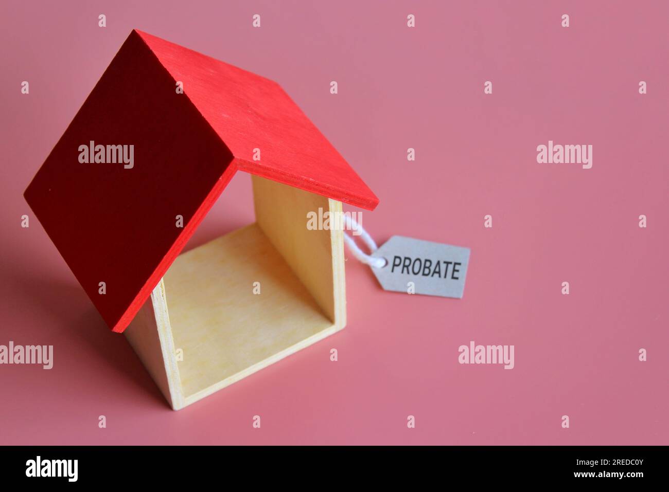 House and tag PROBATE on pink background with copy space for text