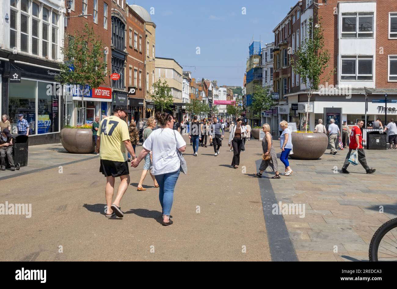 People tourists visitors visiting the busy street town centre shops in summer Westborough Scarborough North Yorkshire England UK Britain Stock Photo