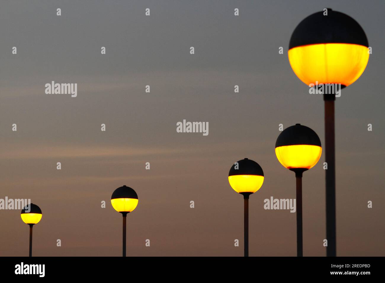 Spherical yellow street lamps on El Morro at sunset, Arica, Chile Stock Photo