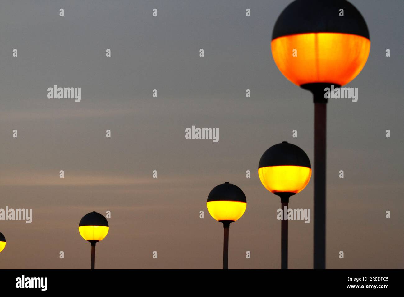 Spherical yellow and orange street lamps on El Morro at sunset, Arica