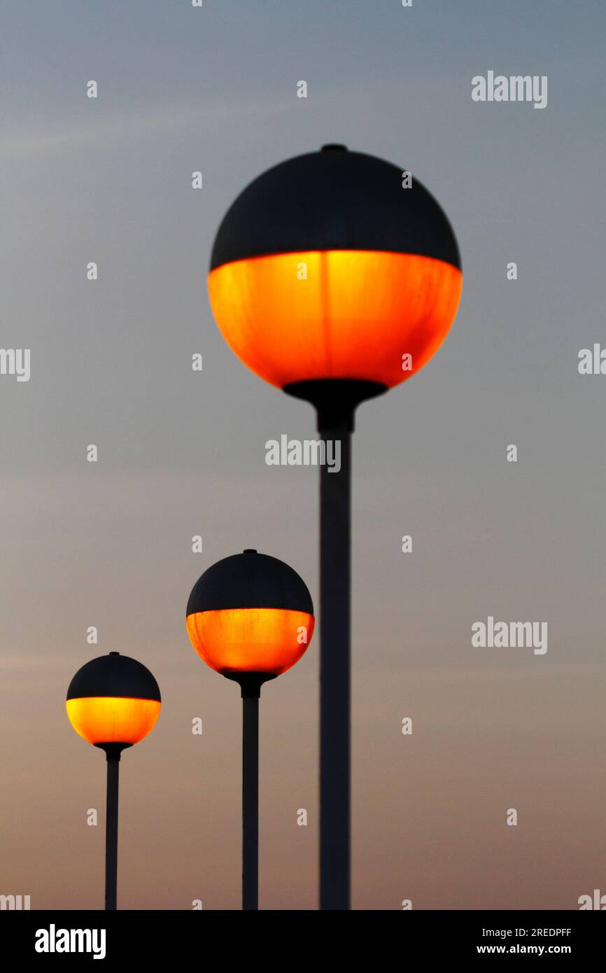 Spherical orange street lamps on El Morro at sunset, Arica, Chile Stock