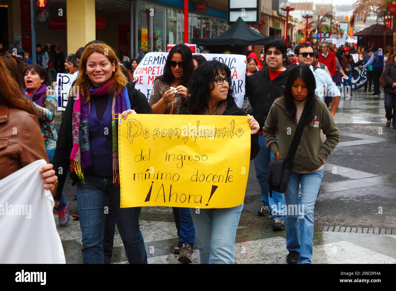 Teachers carrying a banner demanding a rise in the minimum wage for teachers during a protest against government education policies, Arica, Chile Stock Photo