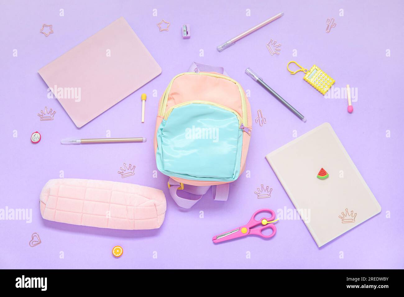 Color school backpack with different stationery on lilac background Stock Photo