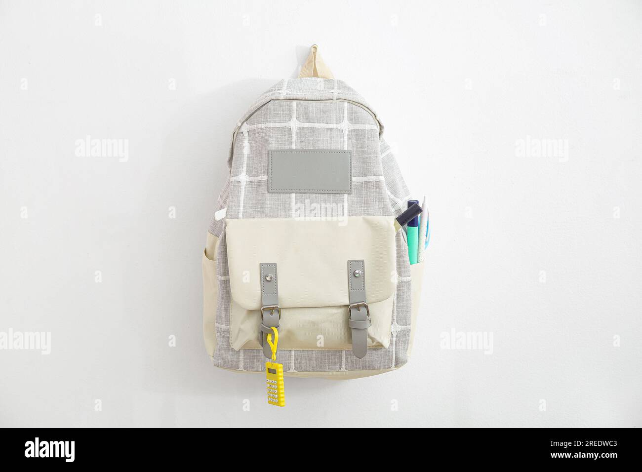Grey school backpack with stationery on white background Stock Photo