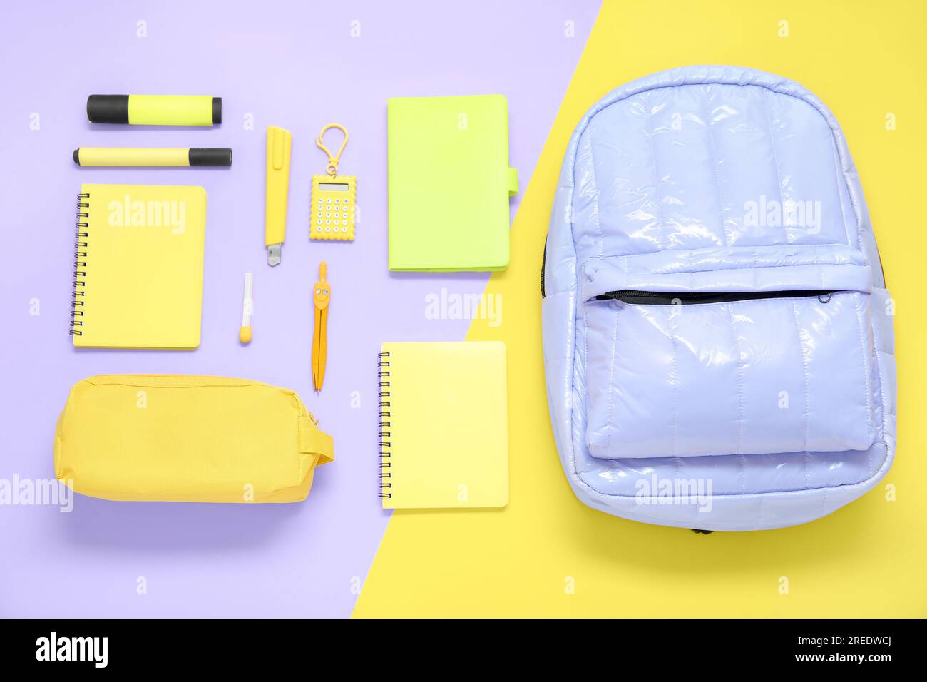 Lilac school backpack with different stationery on color background Stock Photo