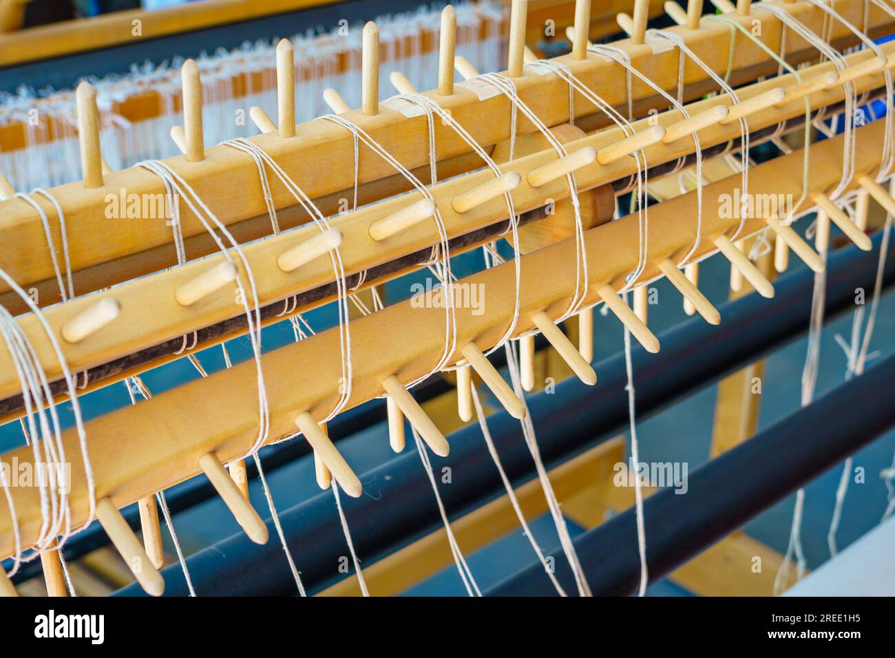 Close-up of a floor loom sectional warp roller with wooden pegs Stock Photo