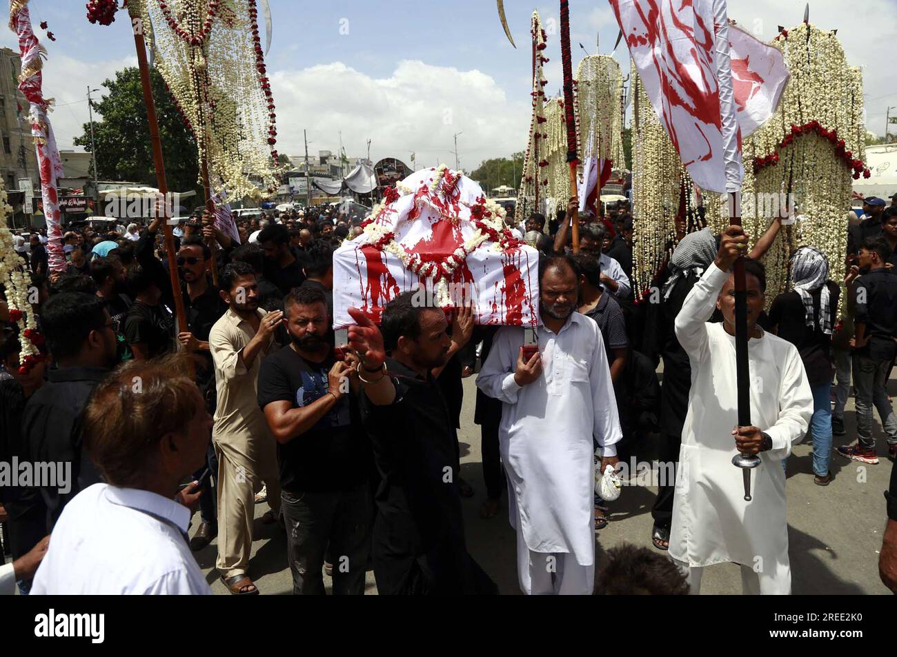 Devotees of Imam Hussain (A.S) are holding religious mourning procession in memories of martyrdom of Hazrat Imam Hussain (AS), grandson of Prophet Mohammad (PBUH), in connection of 8th Muharram-ul-Haram, at M.A Jinnah road in Karachi on Thursday, July 27, 2023. Stock Photo