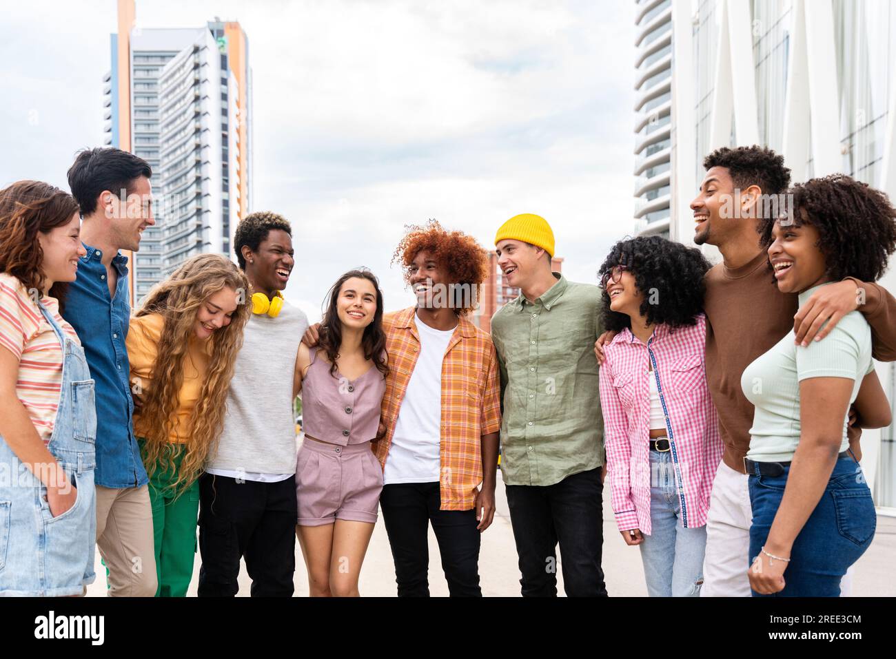 Happy playful multiethnic group of young friends bonding outdoors - Multiracial millennials students meeting in the city, concepts of youth, people li Stock Photo