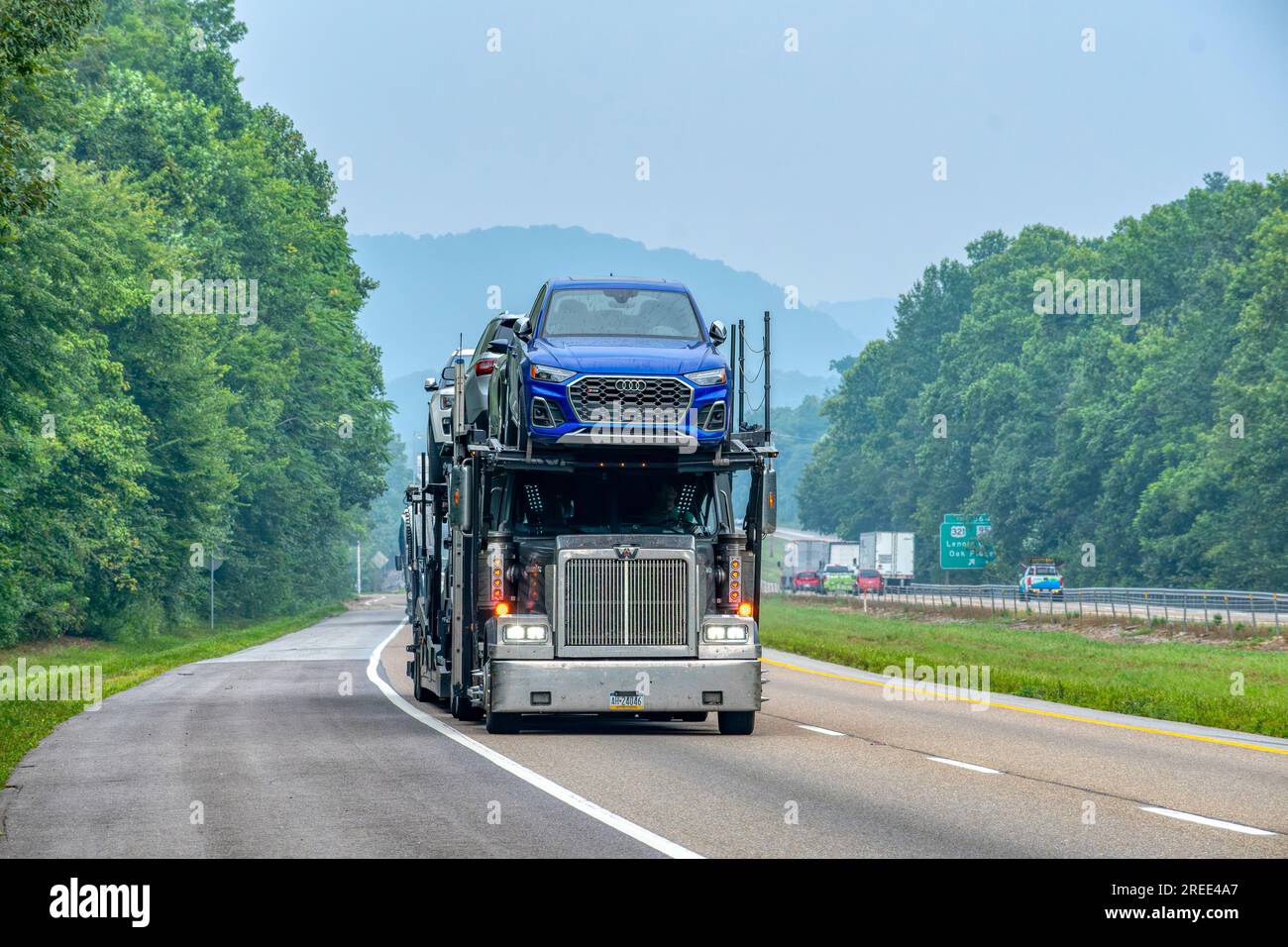 Knoxville, Tennessee, United States – July 18, 2023: Horizontal shot of a car carrier transporting a load of new Audi automobiles in Tennessee. Stock Photo