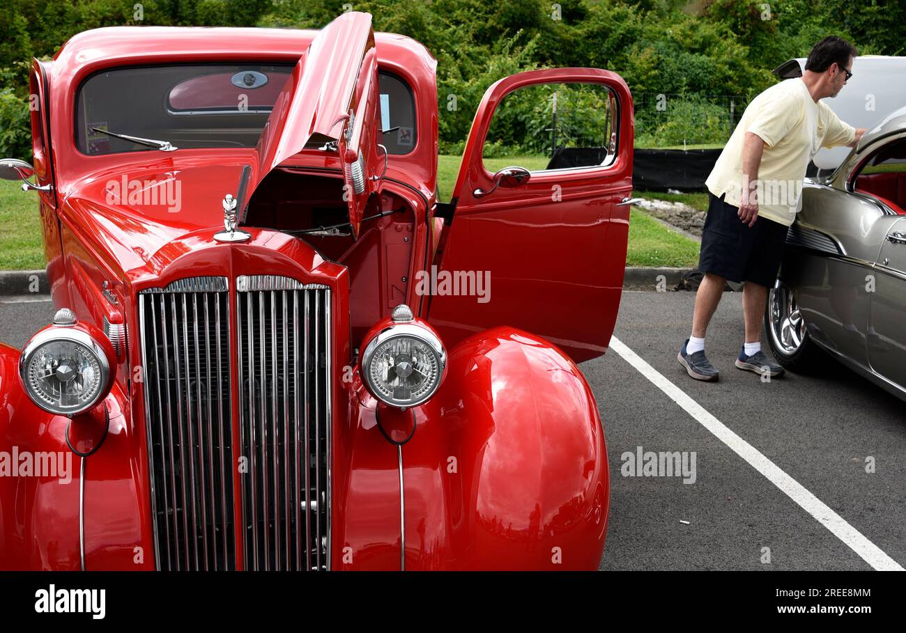 A customized 1937 Packard automobile on display at an antique and