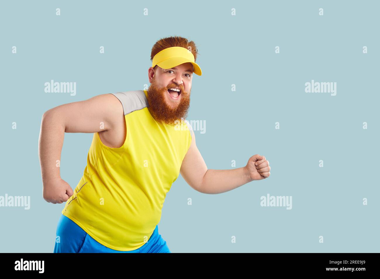 Funny cheerful fat young man in having sports workout, doing exercises