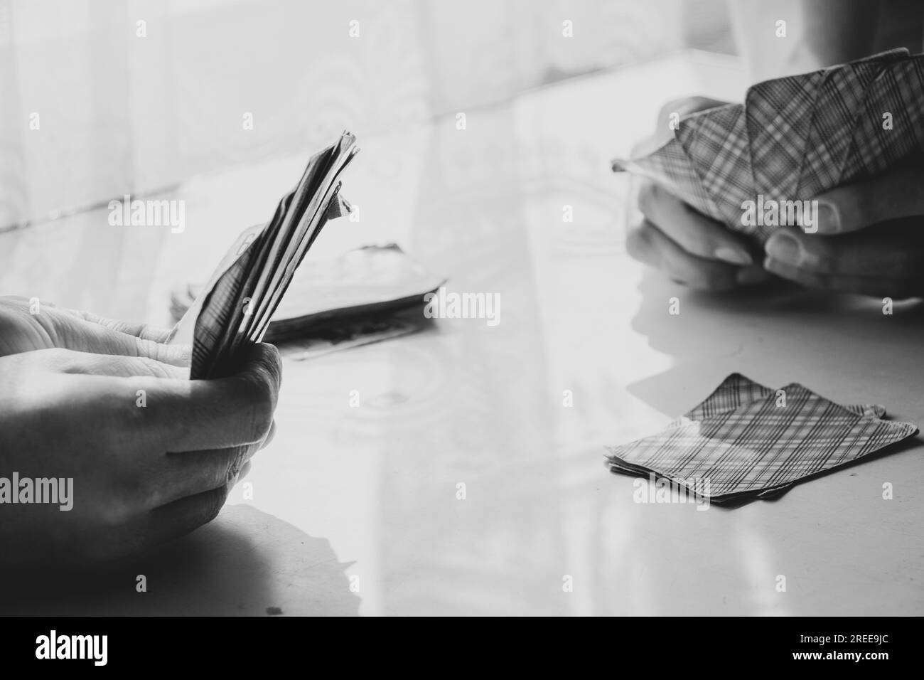 Playing cards at the table near the window at home, gambling board games, hobby Stock Photo