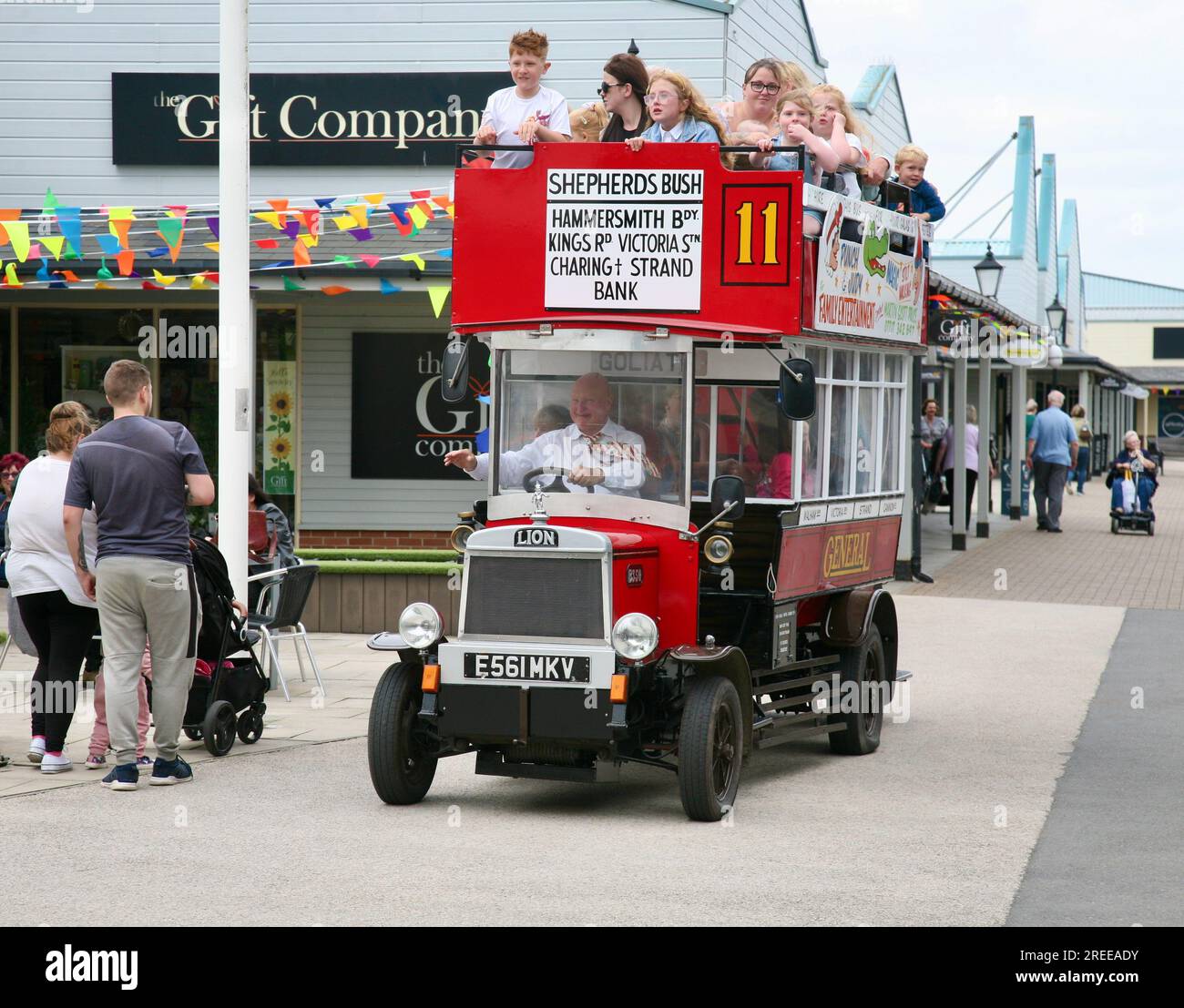 A vintage bus takes holidaymakers for a spin around the Affinity Shopping Mall at the Port of Fleetwood, Lancashire, United Kingdom Stock Photo
