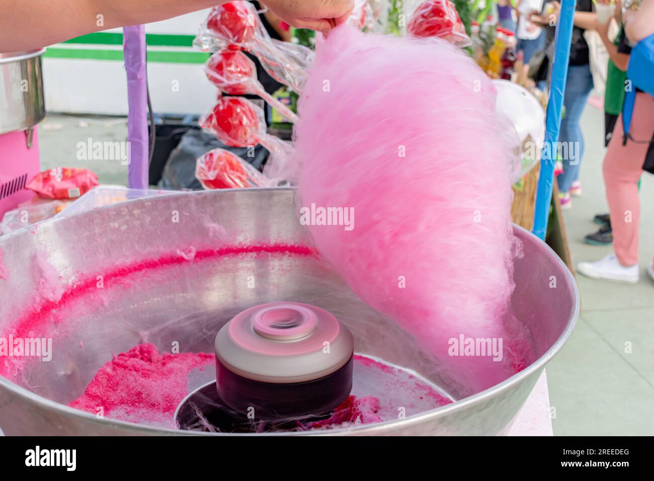 Woman making pink cotton candy at a street fair food stall Stock Photo ...