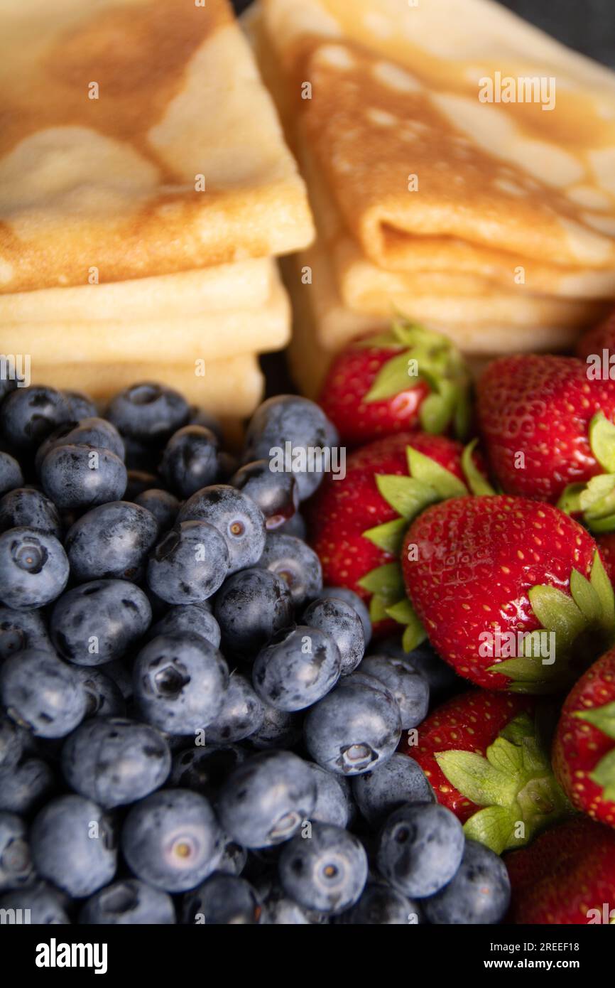 photo of thin pancakes with strawberries and blueberries close up Stock Photo