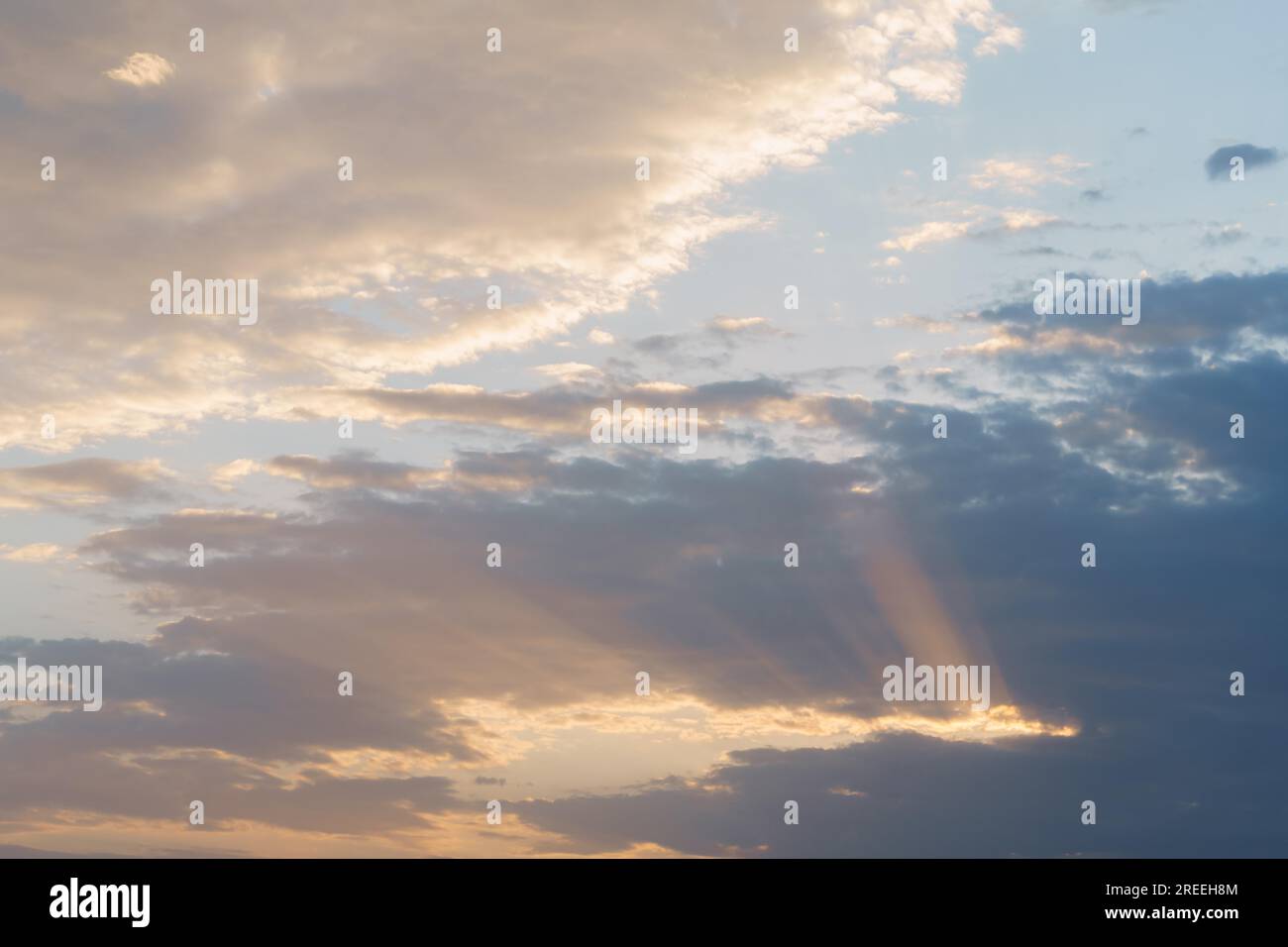 Dramatic cloudy sky with sun rays photographic background Stock Photo