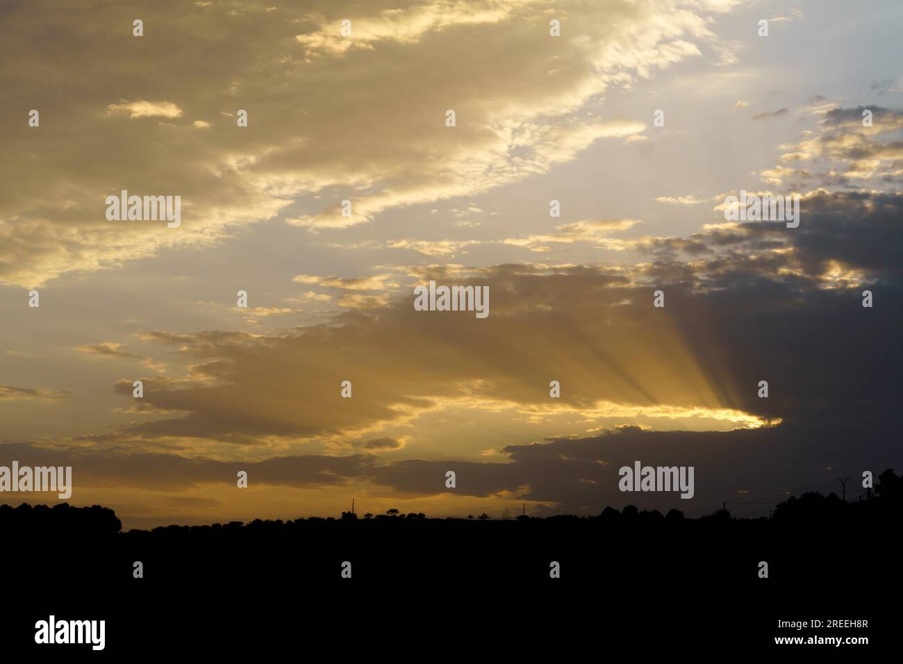 Dramatic cloudy sky with sun rays photographic background Stock Photo